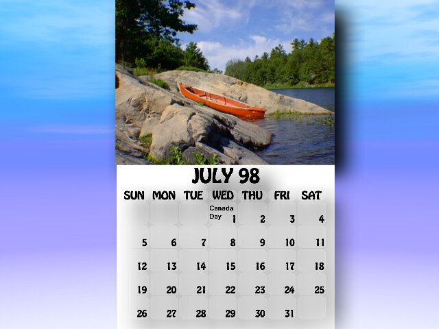 July 1998 Calendar. A canoe resting between some rocks.